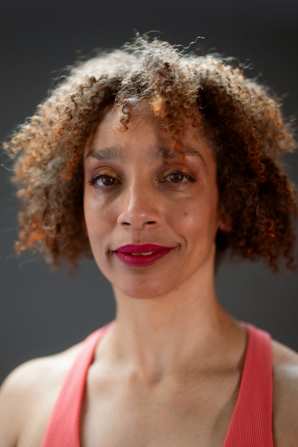 
	Alice Sheppard headshot. Alice is a multiracial Black woman with coffee-colored skin and short curly hair. She smiles softly at the camera; her crimson lip color and coral tank top pops. Photo by Robbie Sweeny.
		